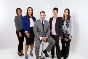 An immigration lawyer with four paralegals standing beside him