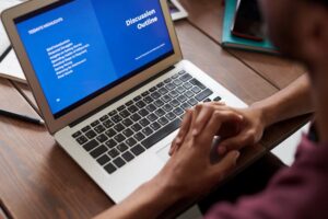 A person sitting in front of a laptop